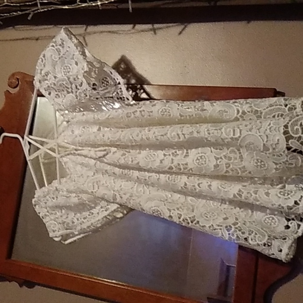 A embroided outer shee with a liner white small blouse